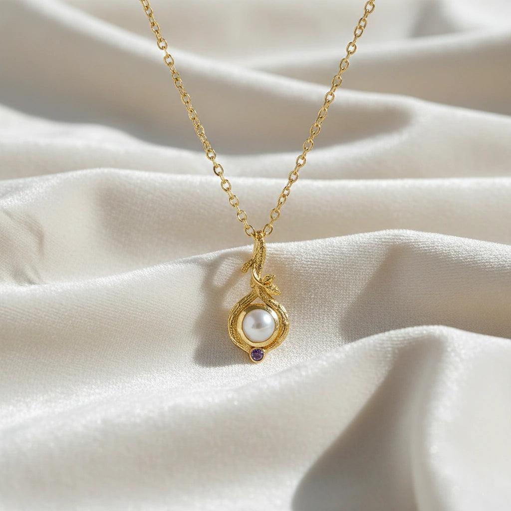 Front_angle_silver_pearl_necklace_with_gold_plated_chain_and_white_pearl_with_amethyst_pearl_necklace_on_silk_background