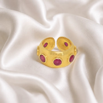 Silver_ruby_ring_in_gold_plated_silver_with_bezel_set_ruby_stones_at_front_view_on_soft_fabric_background