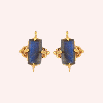Silver_stud_earrings_in_gold_plated_silver_with_baguette_labradorite_stone_at_front_angle_view_on_solid_pink_background