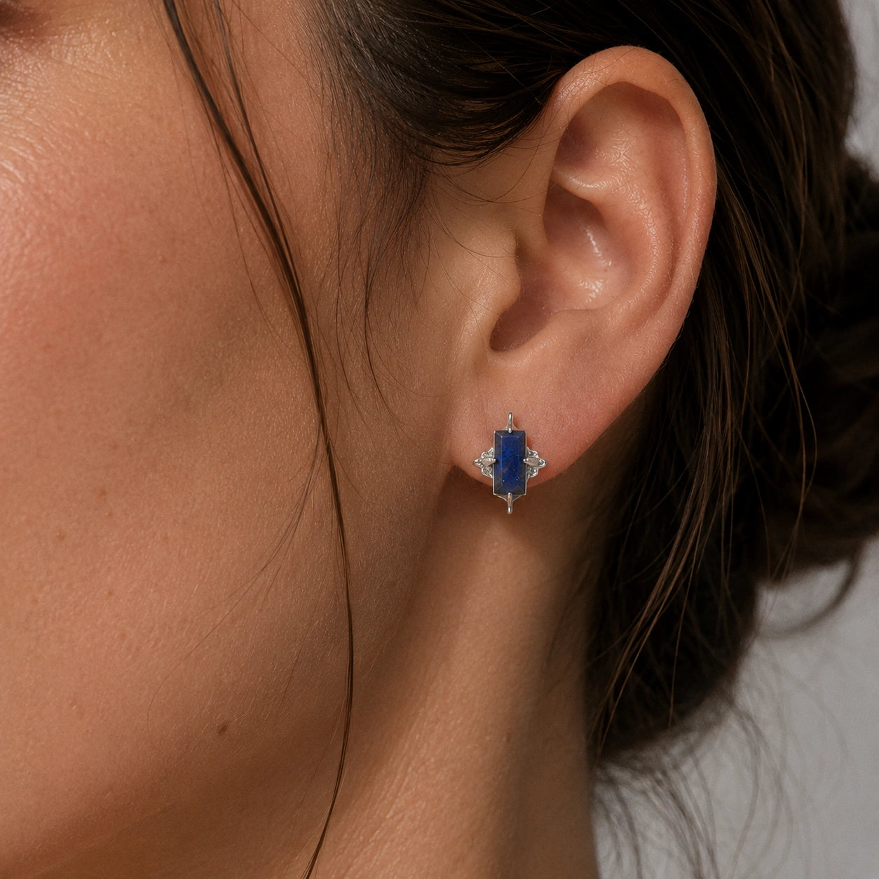 Silver_stud_earrings_in_sterling_silver_with_baguette_labradorite_stone_worn_by_a_model