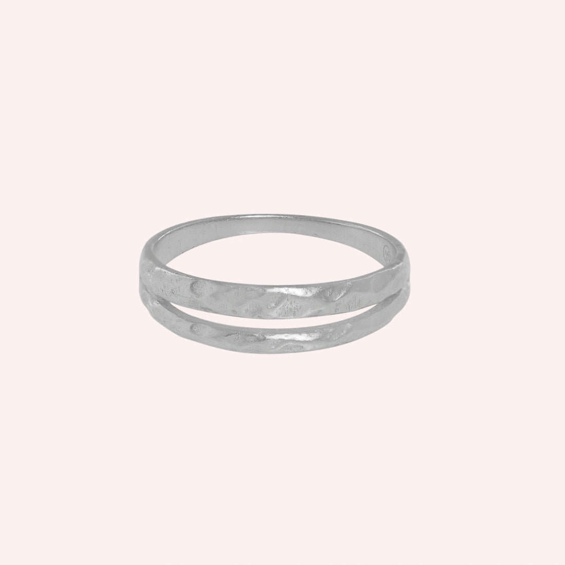 Simple_gold_ring_in_gold_plated_silver_with_split_band_at_front_angle_on_solid_pink_background