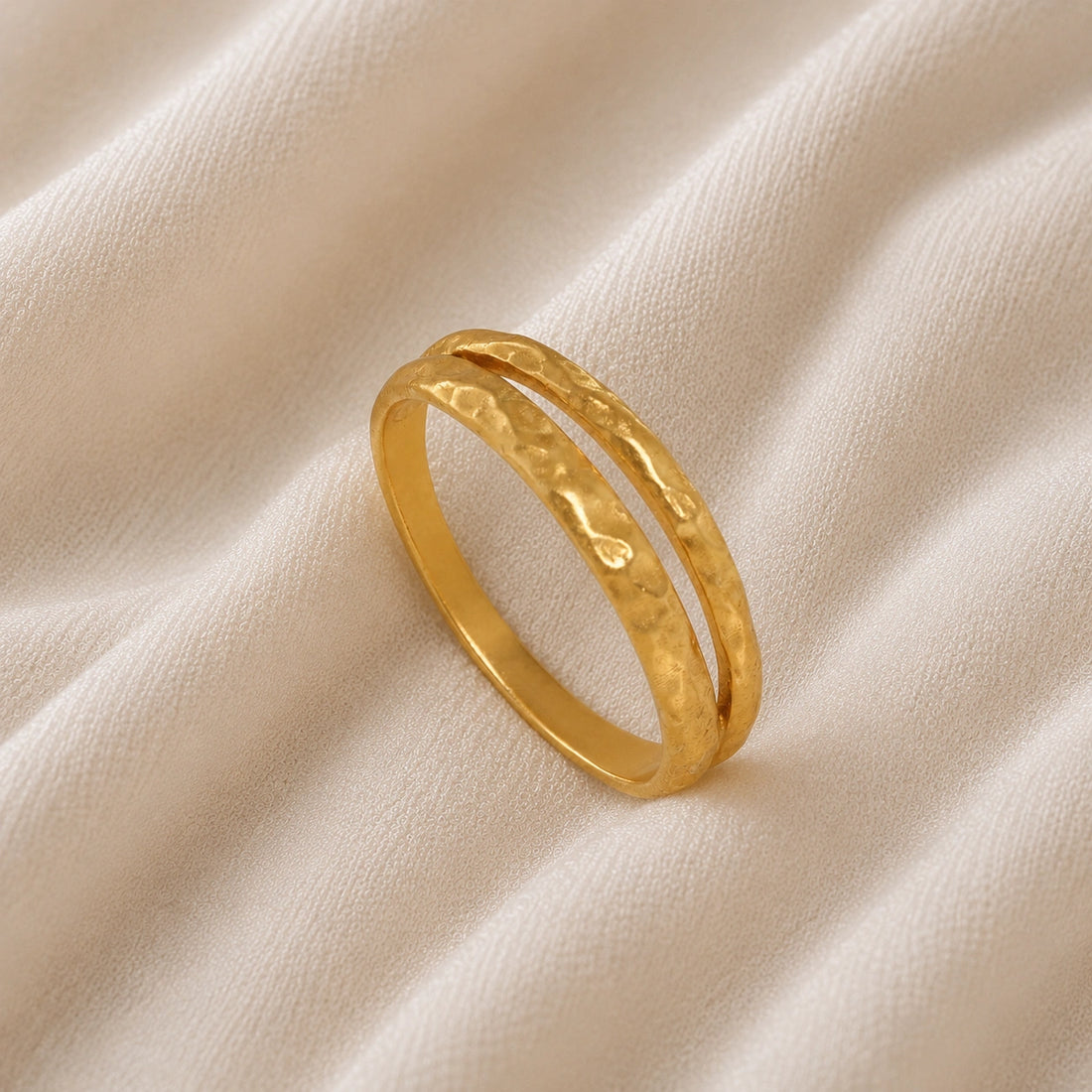 Simple_gold_ring_in_gold_plated_silver_with_split_band_at_slight_angle_on_soft_fabric_background