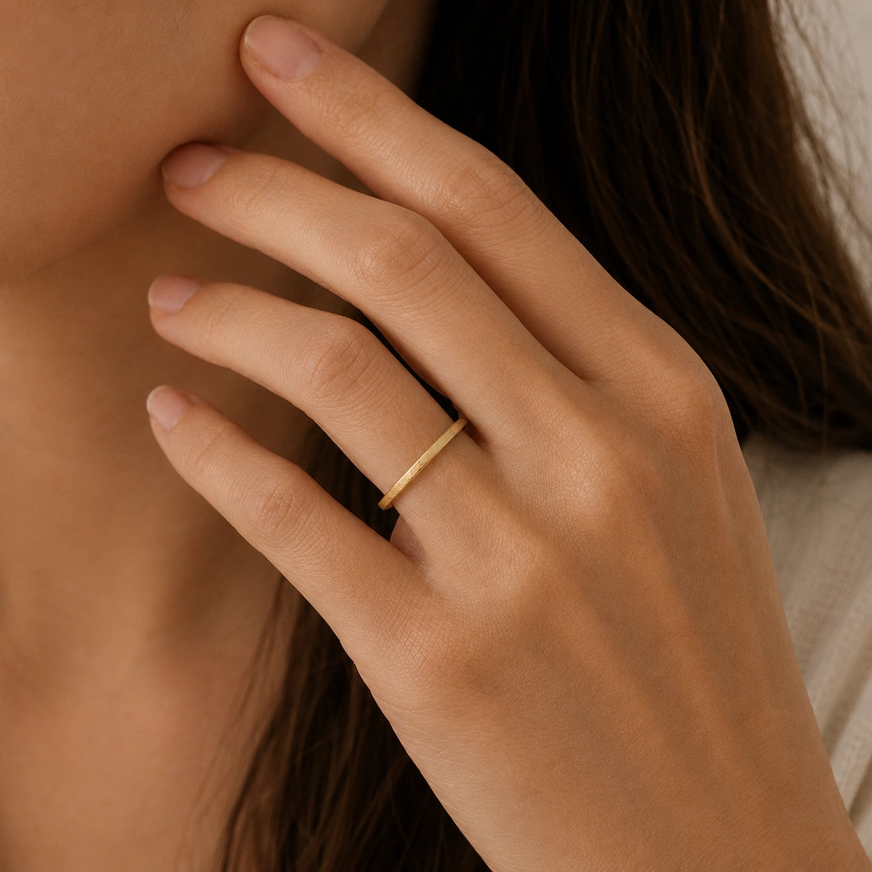 Simple_ring_in_gold_plated_silver_with_a_textured_band_worn_by_a_model