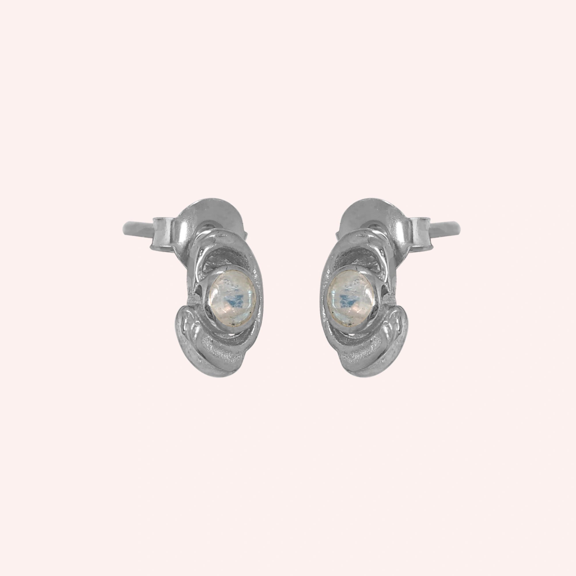Small-stud-earrings-with-moonstone-sterling-silver-slight-angled-view-on-soft-pink-background