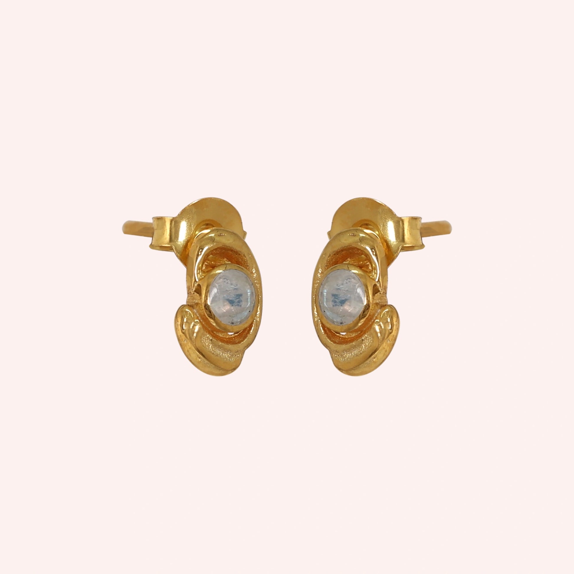 Small-stud-earrings-with-moonstone-gold-plated-silver-slight-angled-view-on-soft-pink-background
