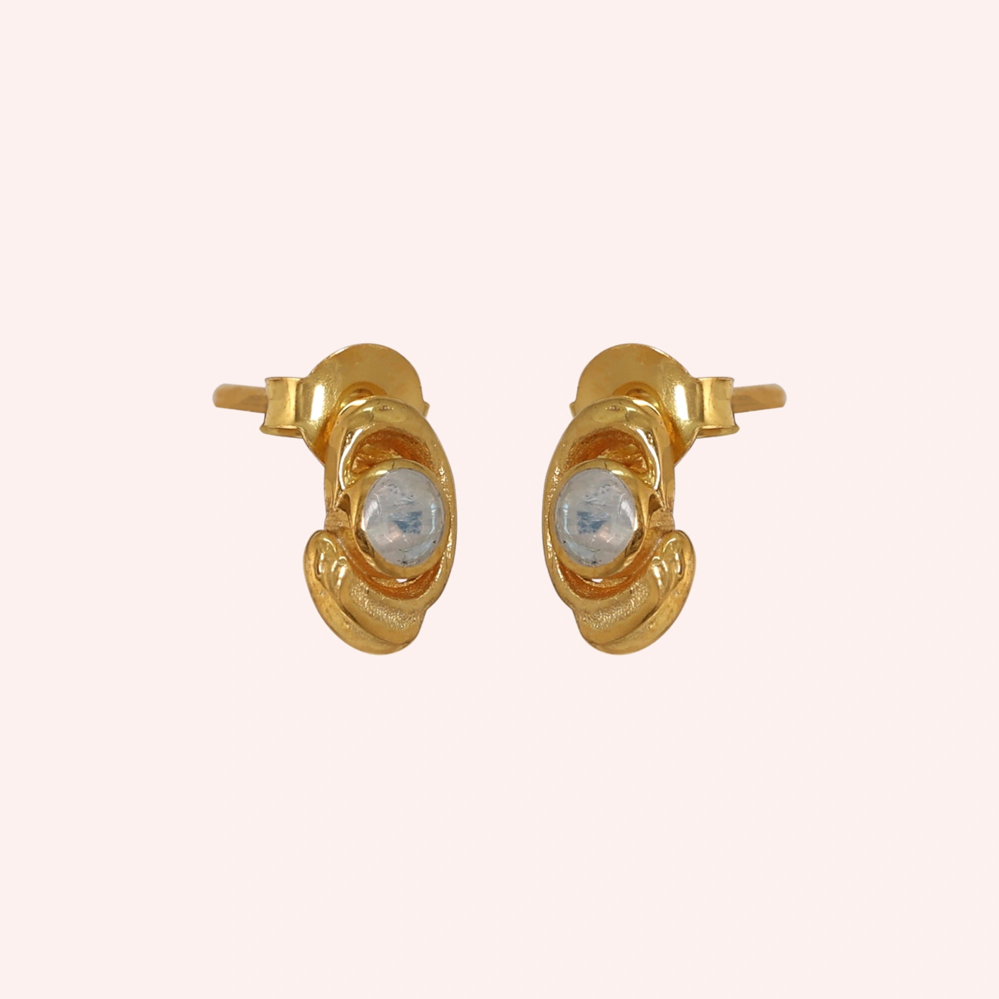 Small-stud-earrings-with-moonstone-gold-plated-silver-slight-angled-view-on-soft-pink-background