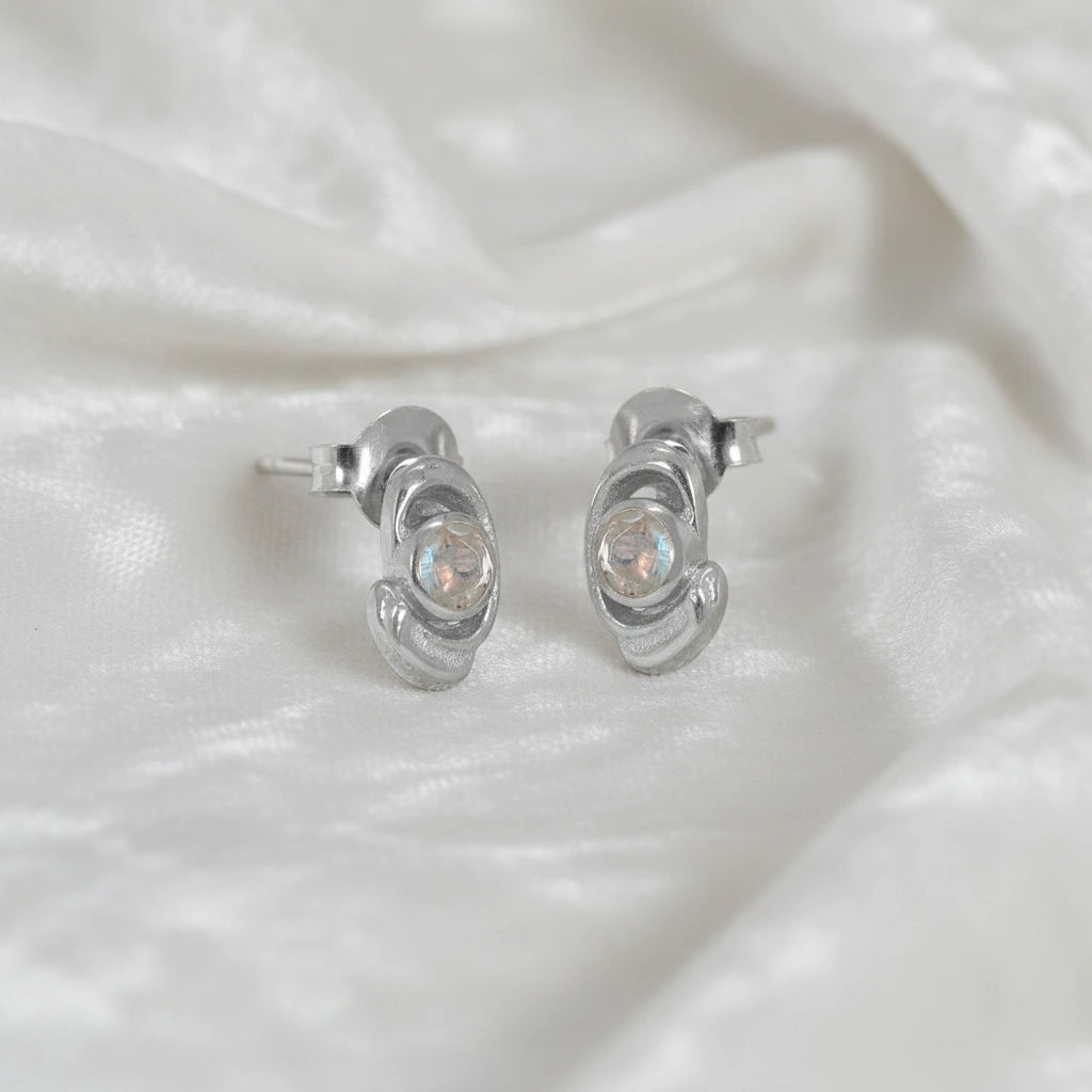 Small-stud-earrings-with-moonstone-sterling-silver-slight-angled-view-on-white-satin-background