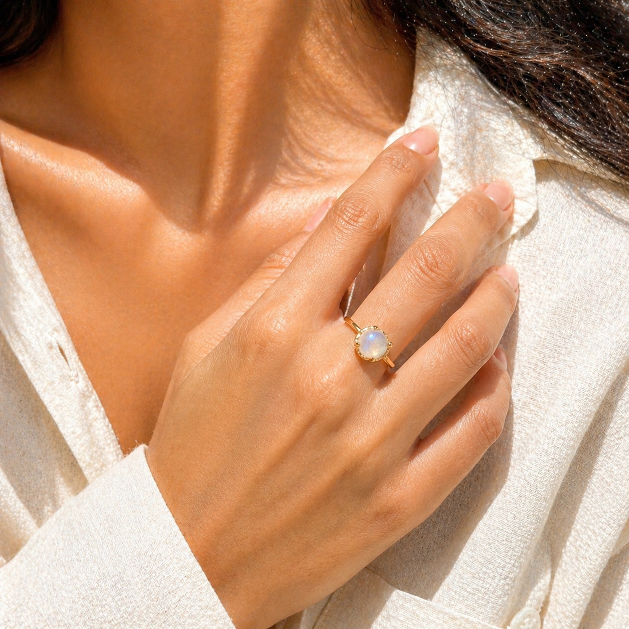 Solitaire_ring_in_gold_plated_ring_with_round_moonstone_worn_by_a_model