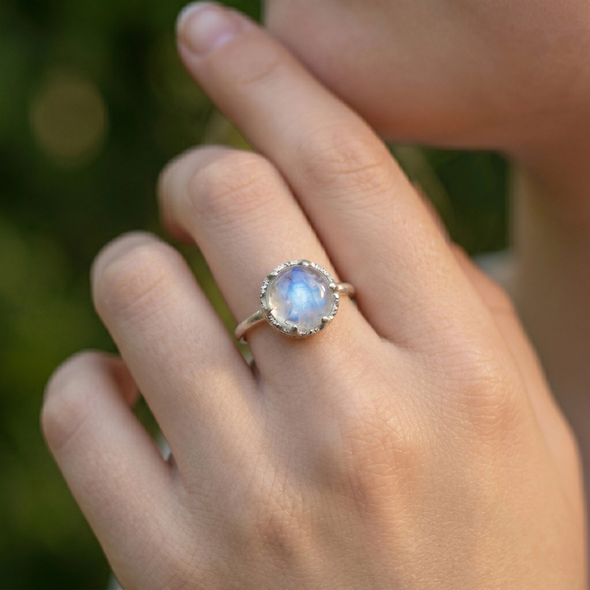Solitaire_ring_in_gold_plated_ring_with_round_moonstone_worn_by_a_model