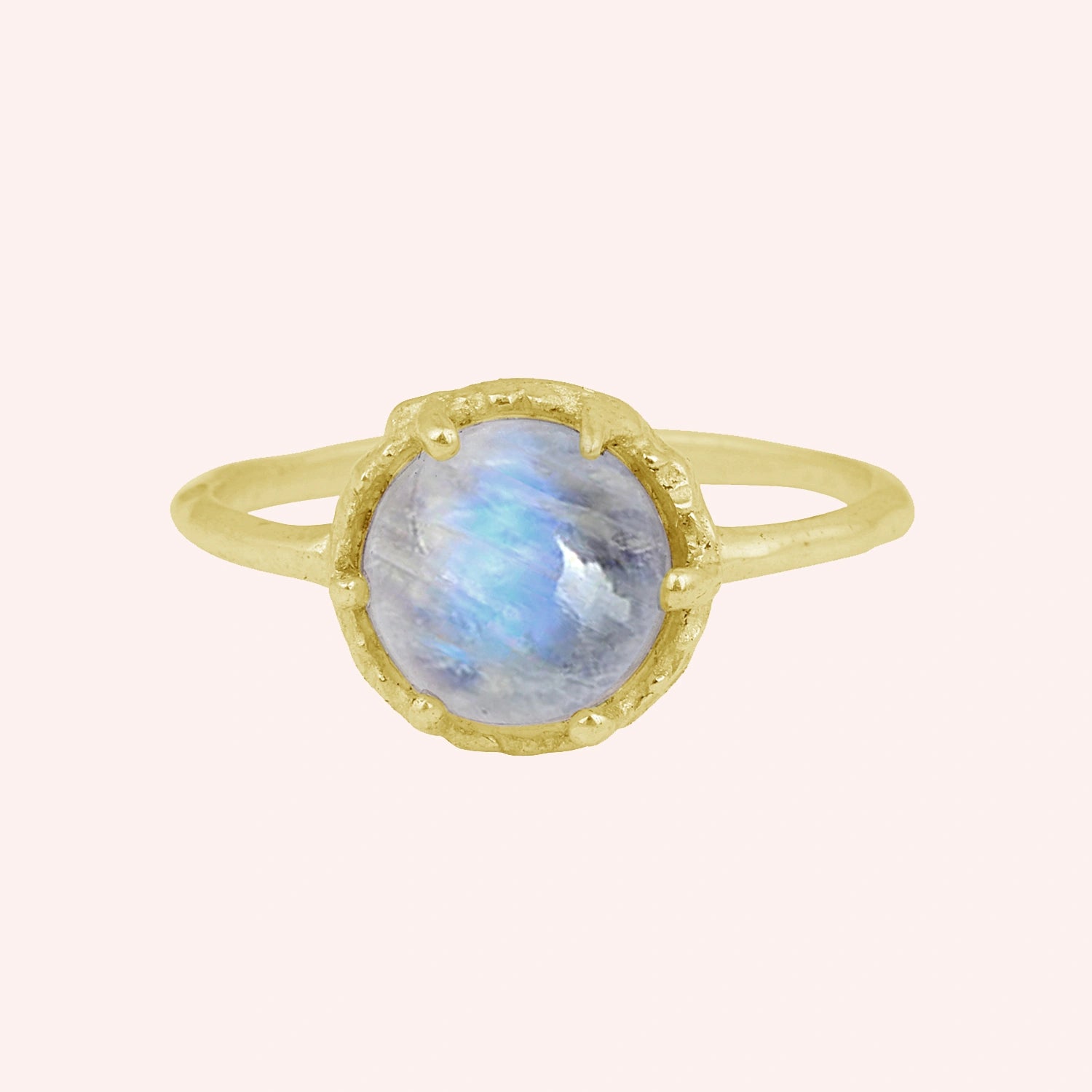 Solitaire_ring_in_gold_plated_ring_with_round_moonstone_shown_in_front_angle_view_on_solid_pink_background