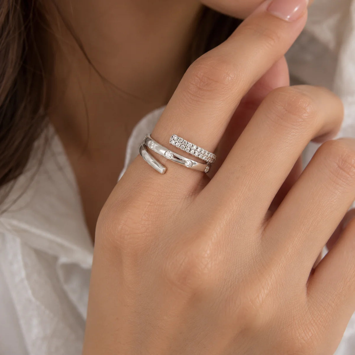 Spiral_ring_in_front_silver_with_lab_grown_diamonds_at_front_angle_view_worn_by_a_model