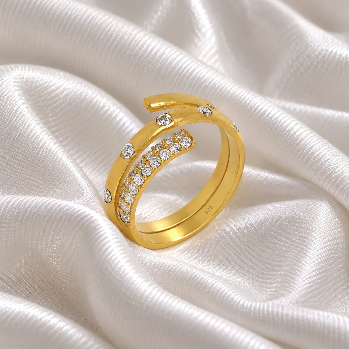 Spiral_ring_in_gold_plated_silver_with_lab_grown_diamonds_at_side_angle_view_on_soft_fabric_background