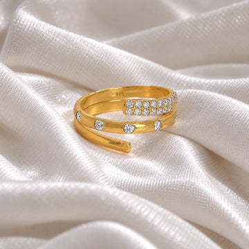 Spiral_ring_in_gold_plated_silver_with_lab_grown_diamonds_at_front_angle_view_on_soft_fabric_background