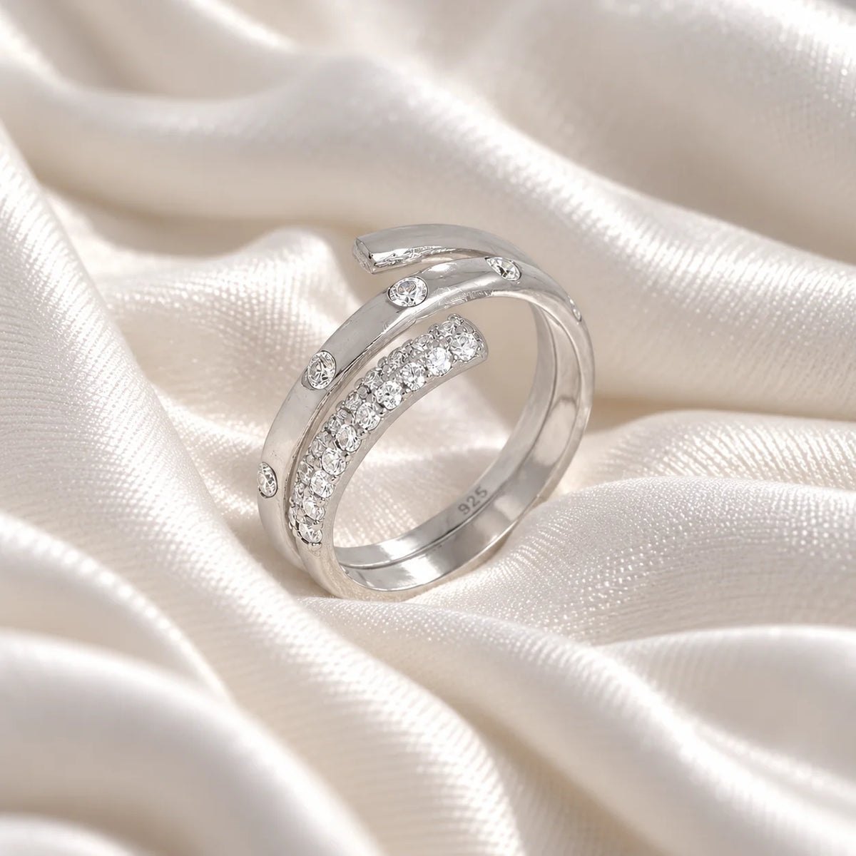 Spiral_ring_in_sterling_silver_with_lab_grown_diamonds_at_side_angle_view_on_soft_fabric_background