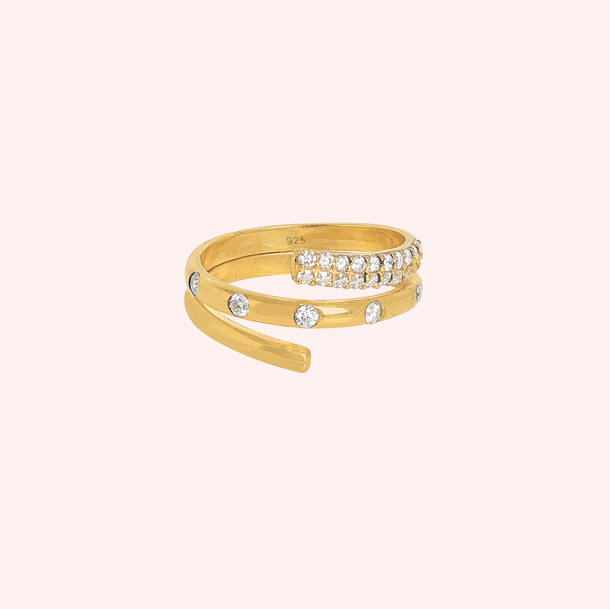 Spiral_ring_in_gold_plated_silver_with_lab_grown_diamonds_at_front_angle_view_on_solid_pink_background