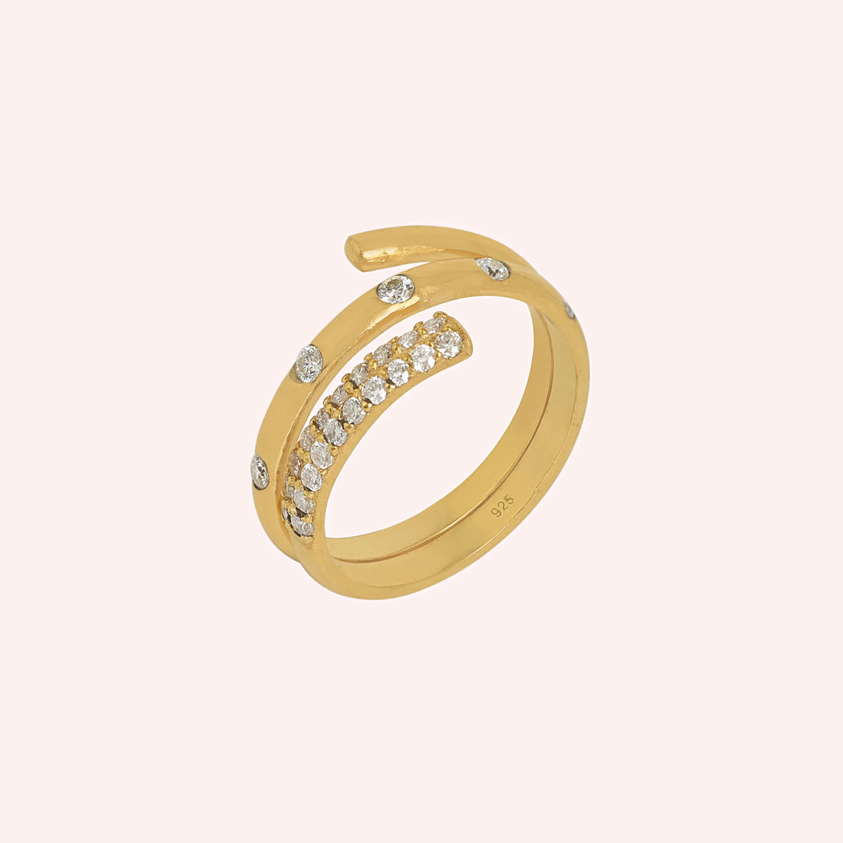 Spiral_ring_in_gold_plated_silver_with_lab_grown_diamonds_at_side_angle_view_on_solid_pink_background