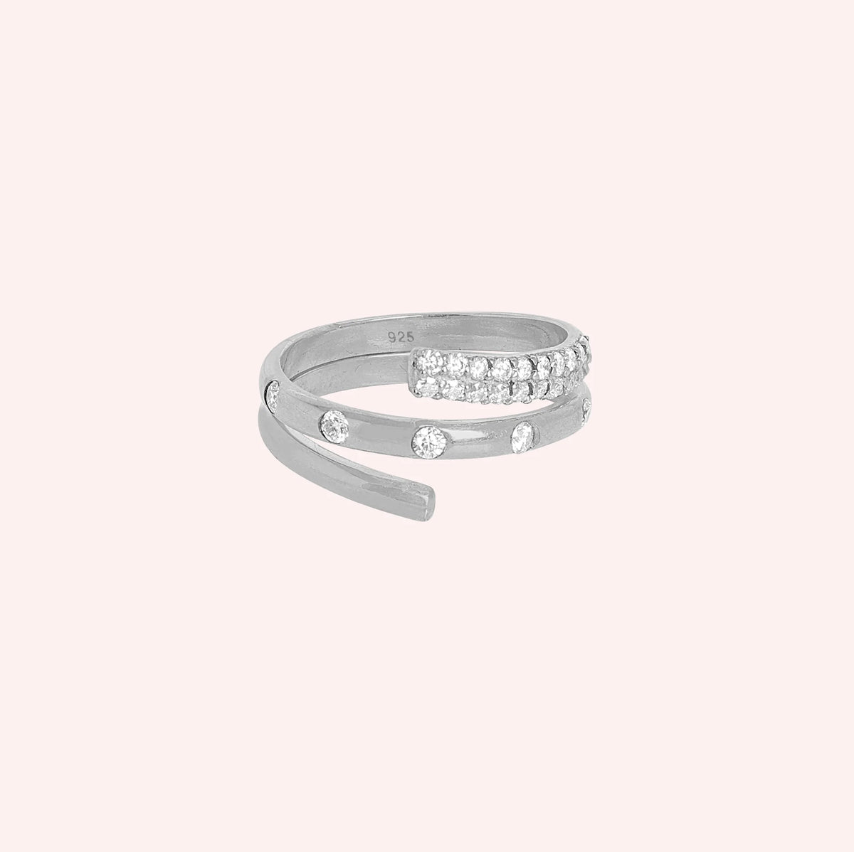 Spiral_ring_in_front_silver_with_lab_grown_diamonds_at_front_angle_view_on_solid_pink_background