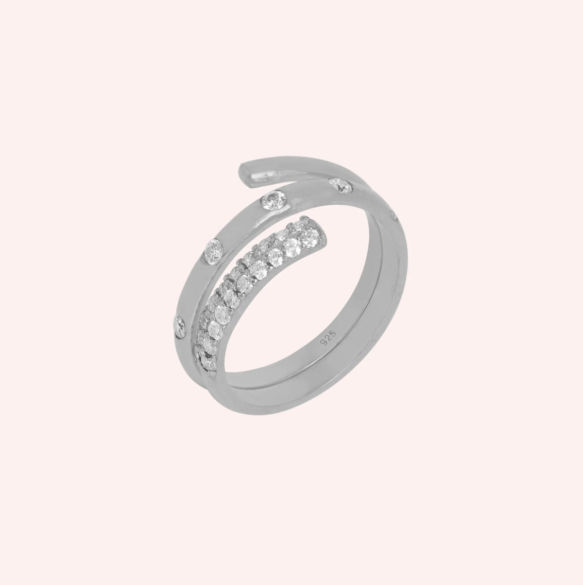 Spiral_ring_in_sterling_silver_with_lab_grown_diamonds_at_side_angle_view_on_solid_pink_background