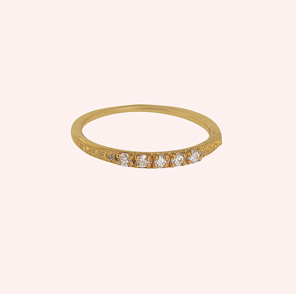 Stackable_ring_in_gold_plated_silver_with_lab_grown_diamonds_at_front_angle_view_on_solid_pink_background
