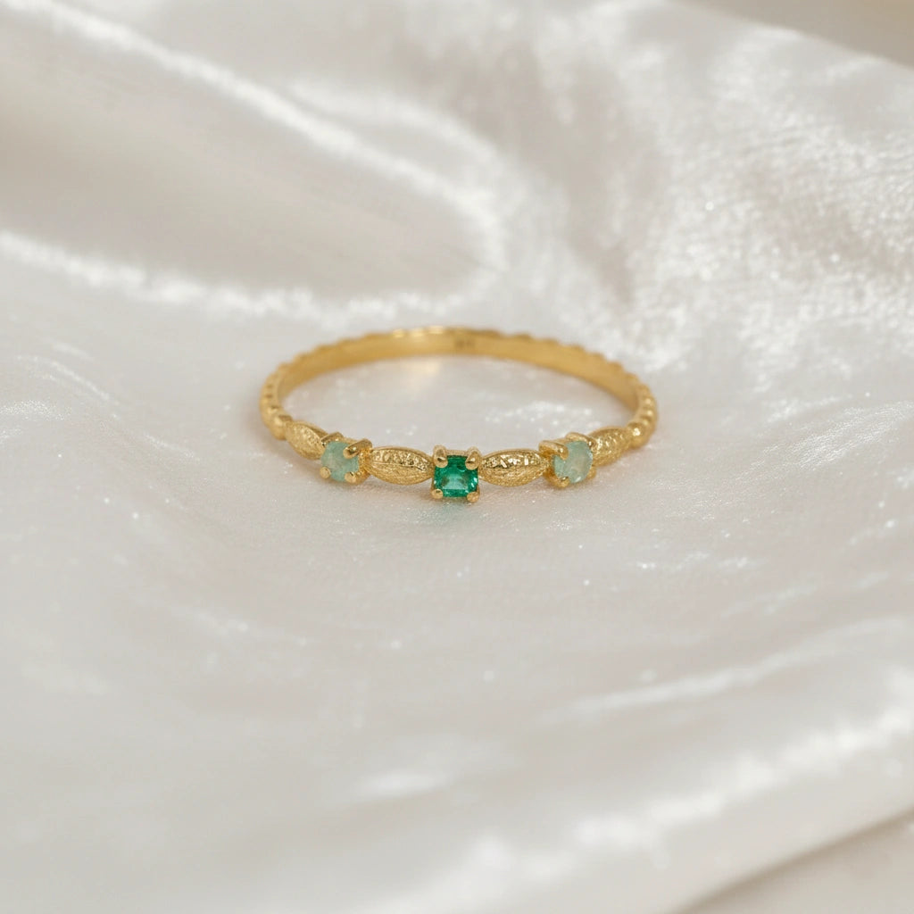Stackable-ring-with-green-gemstones-gold-plated-silver-front-view-on-white-satin-background