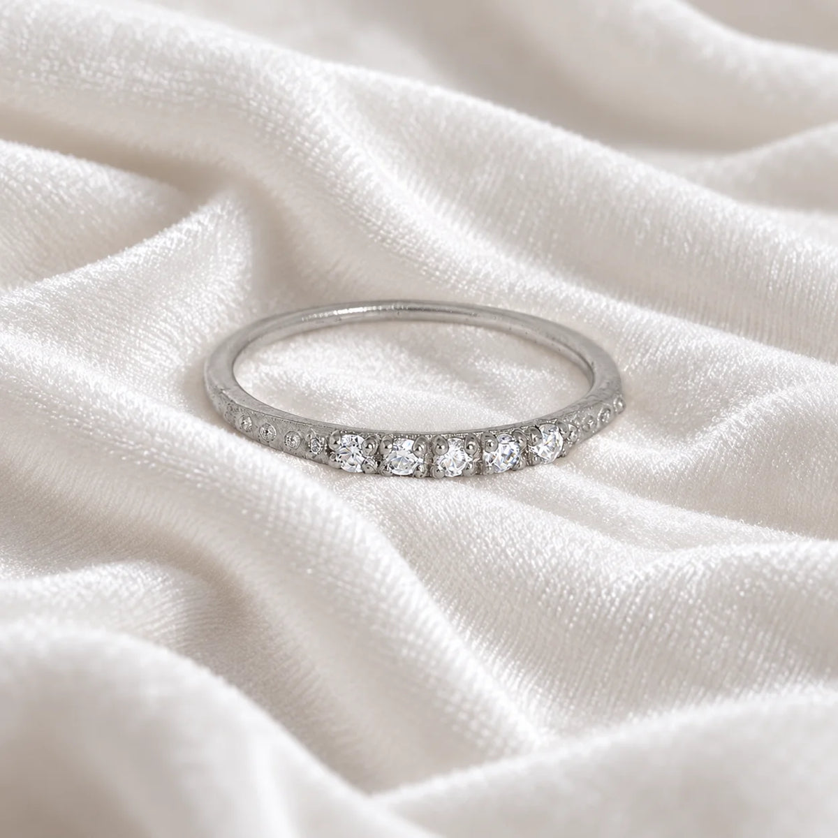 Stackable_ring_in_sterling_silver_with_lab_grown_diamonds_at_front_angle_view_on_soft_fabric_background
