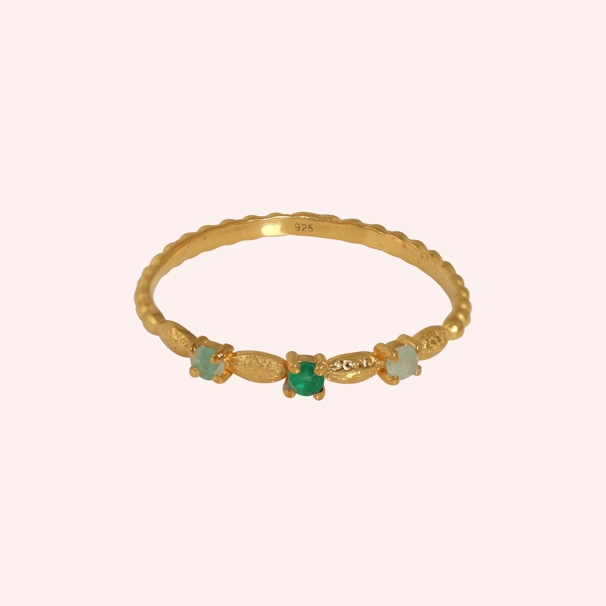 Stackable-ring-with-green-gemstones-gold-plated-silver-front-view-on-soft-pink-background