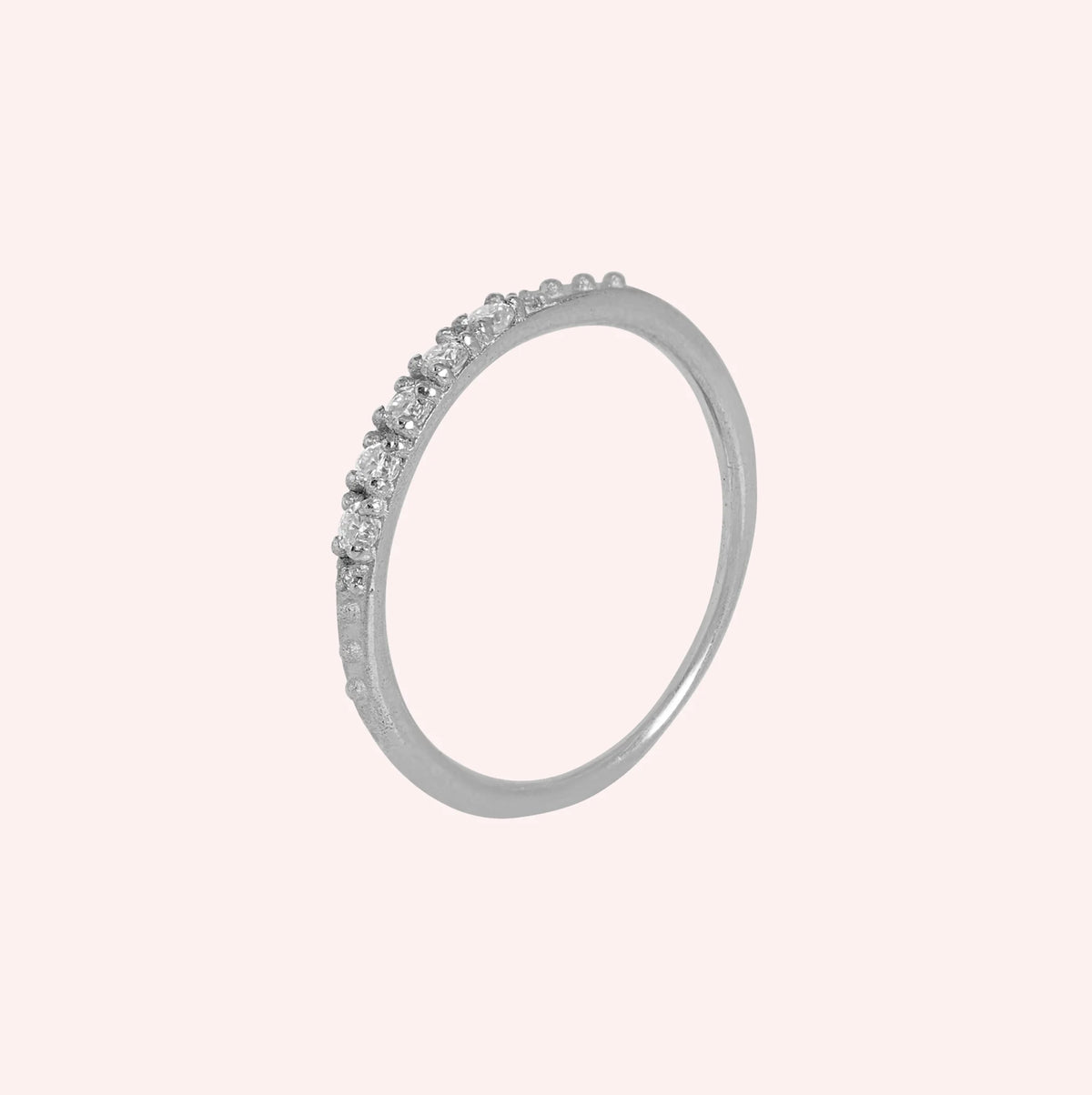 Stackable_ring_in_sterling_silver_with_lab_grown_diamonds_at_side_angle_view_on_solid_pink_background