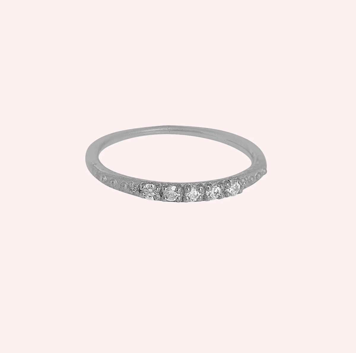 Stackable_ring_in_sterling_silver_with_lab_grown_diamonds_at_front_angle_view_on_solid_pink_background