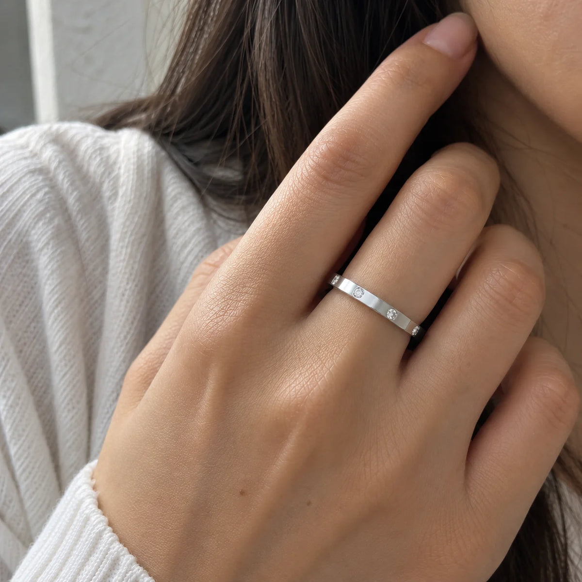 Stacking_ring_in_gold_plated_silver_with_a_round_CZ_stones_at_front_angle_view_worn_by_a_model