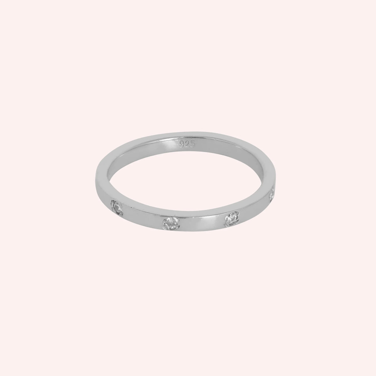 Stacking_ring_in_sterling_silver_with_lab_grown_diamonds_at_front_angle_view_on_solid_pink_background