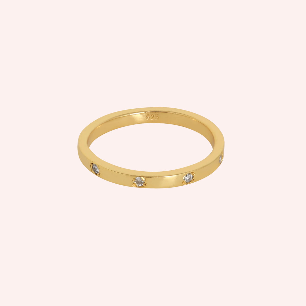 Stacking_ring_in_gold_plated_silver_with_lab_grown_diamonds_at_front_angle_view_on_solid_pink_background