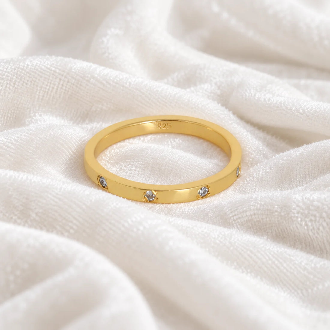 Stacking_ring_in_gold_plated_silver_with_lab_grown_diamonds_at_front_angle_view_on_soft_fabric_background