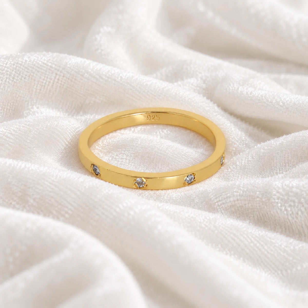 Stacking_ring_in_gold_plated_silver_with_lab_grown_diamonds_at_front_angle_view_on_soft_fabric_background