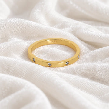 Stacking_ring_in_gold_plated_silver_with_lab_grown_diamonds_at_front_angle_view_on_soft_fabric_background