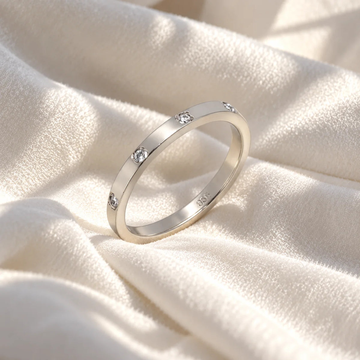 Stacking_ring_in_sterling_silver_with_lab_grown_diamonds_at_slight_angle_view_on_soft_fabric_background