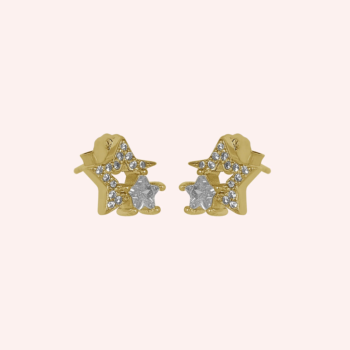 Star_earrings_in_gold_plated_silver_with_CZ_stones_at_side_angle_view_on_solid_pink_background