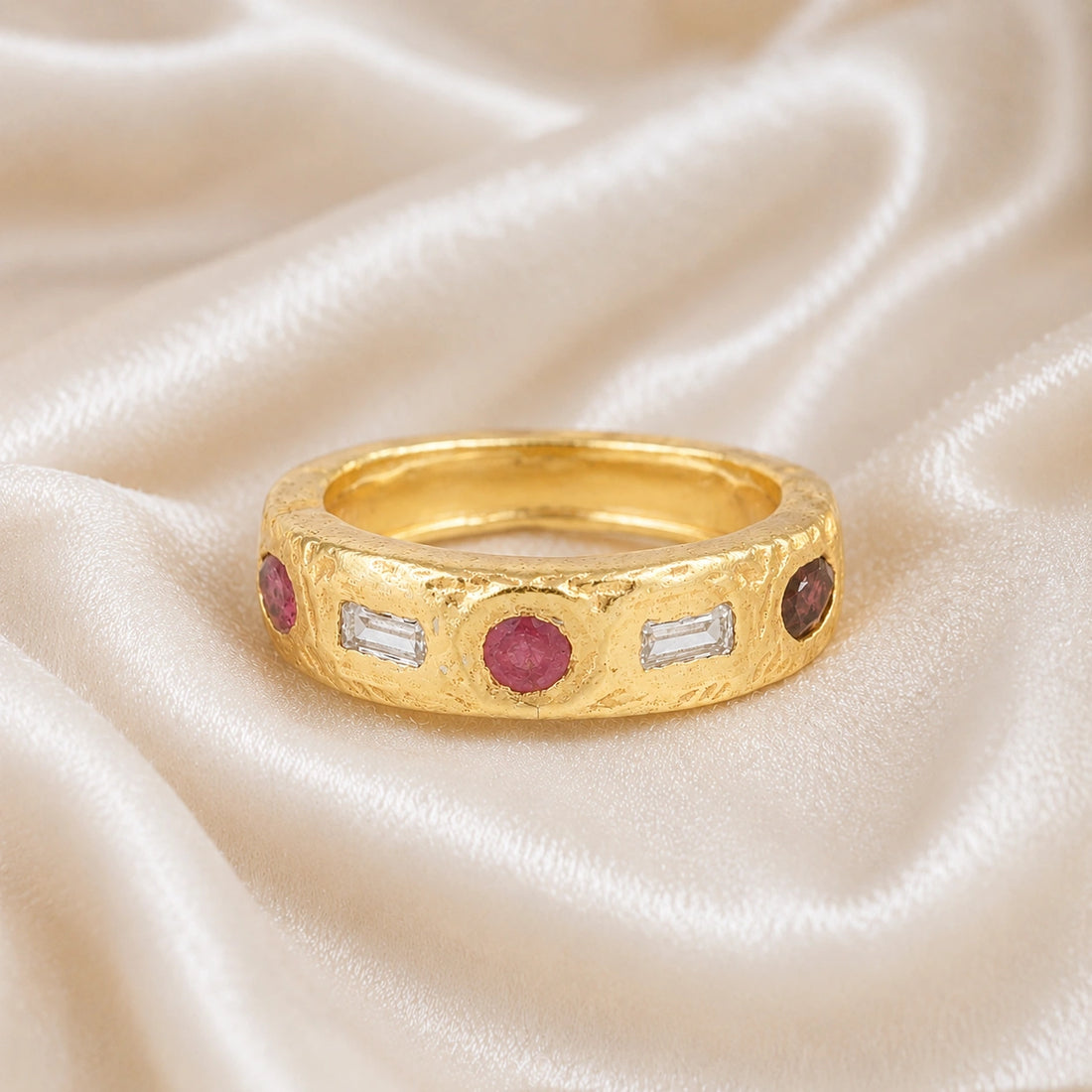 Statement_ring_in_gold_plated_silver_at_front_angle_with_multi_stones_on_a_soft_fabric_background