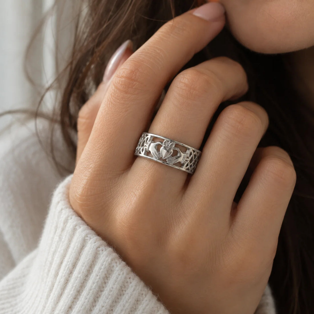 Statement_ring_in_gold_plated_silver_with_claddagh_design_band_at_front_angle_view_on_soft_fabric_background