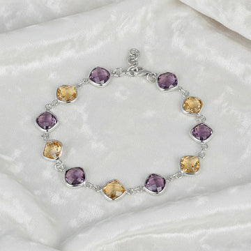 sterling_silver_gemstone_bracelet_top_view_amethyst_citrine_bracelet_on_white_velvet_background_soft_texture