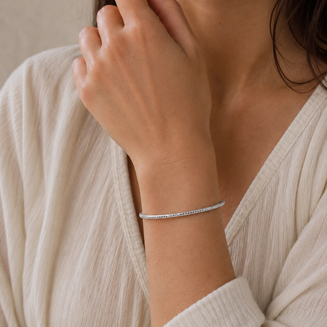 Sterling_silver_bracelet_in_sterling_silver_with_engraved_design_worn_by_a_model