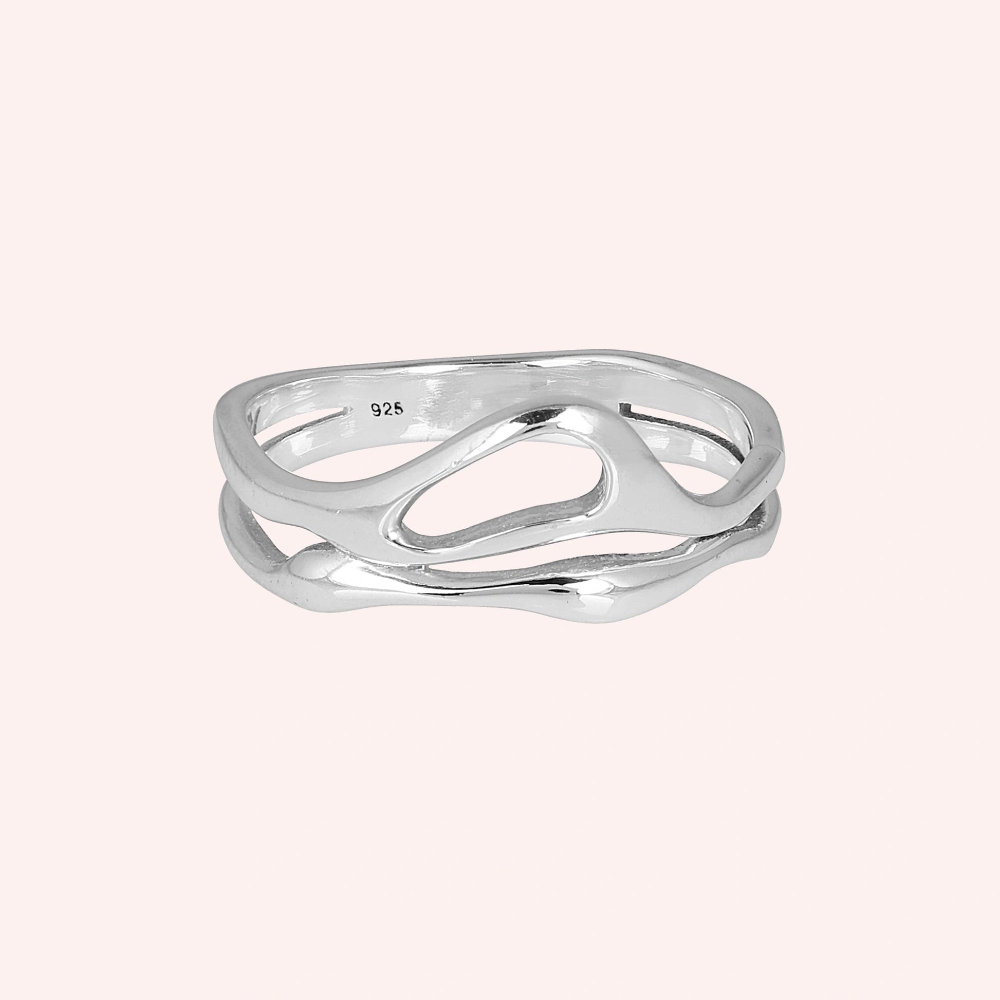 A front angle view of sterling silver rings for women on a pink background featuring a smooth and polished wave band ring design