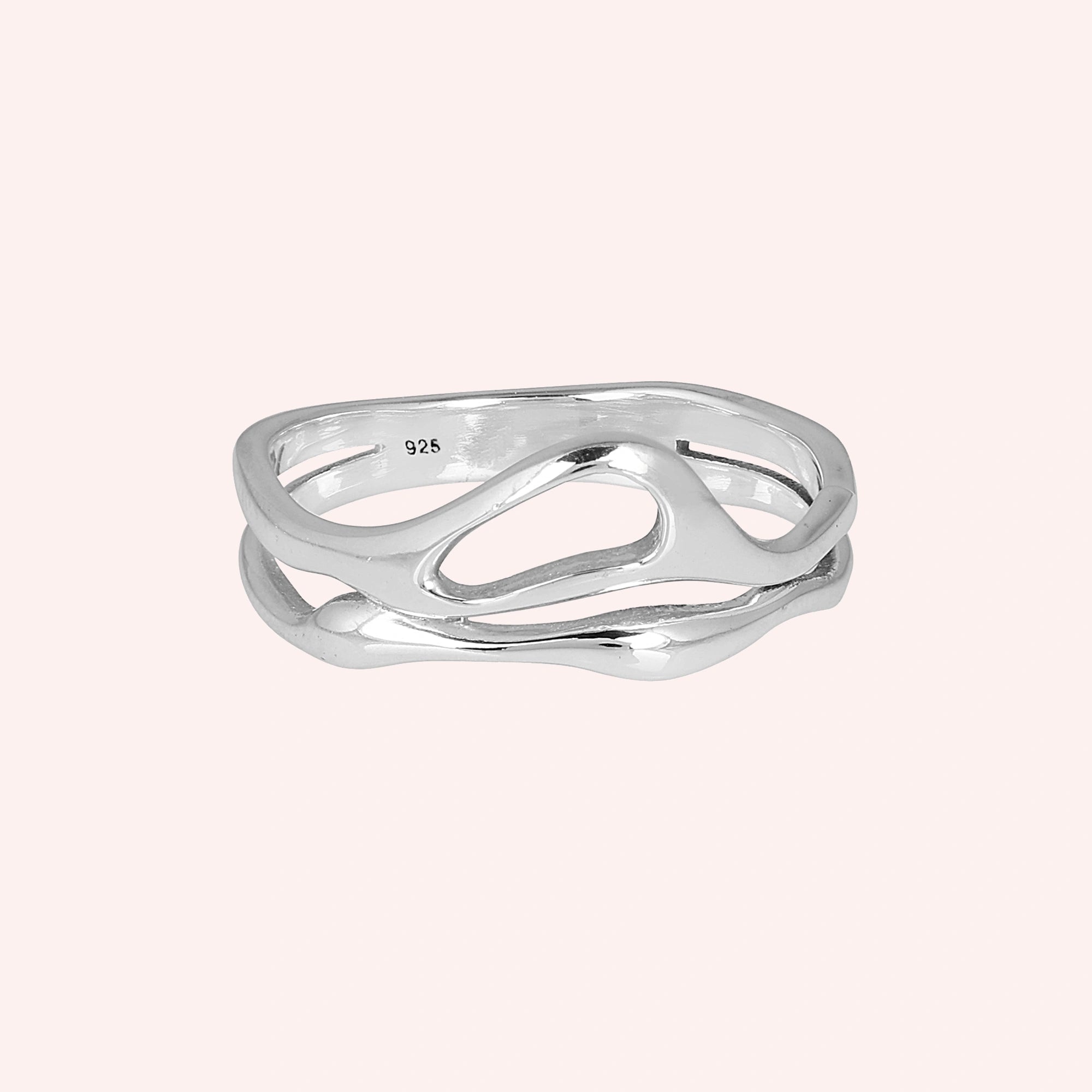 A front angle view of sterling silver rings for women on a pink background featuring a smooth and polished wave band ring design