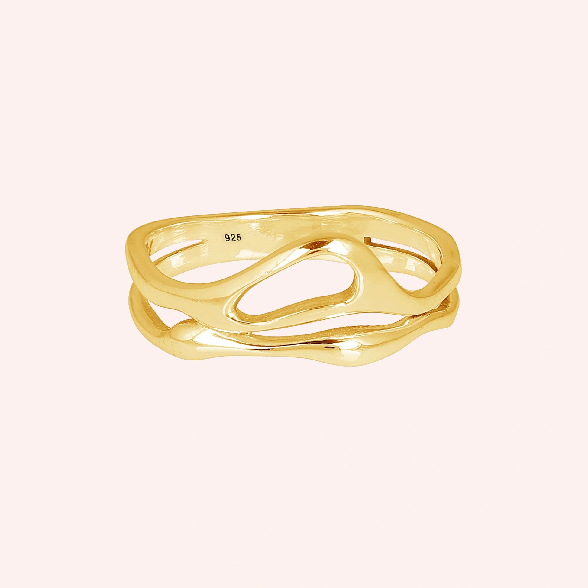 A gold vermeil wave band ring on a pink background shown from a front angle as a polished sterling silver rings for women style