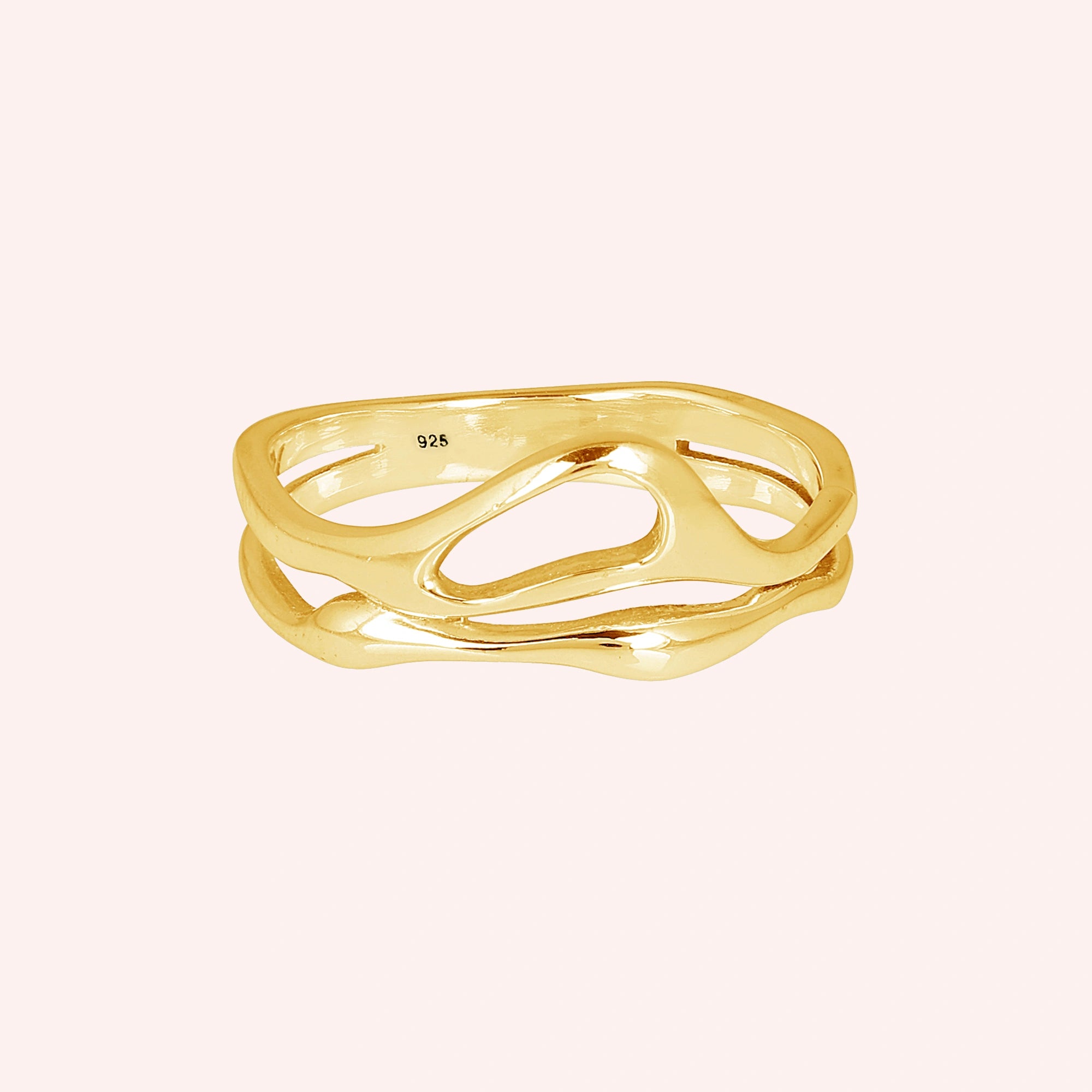 A gold vermeil wave band ring on a pink background shown from a front angle as a polished sterling silver rings for women style