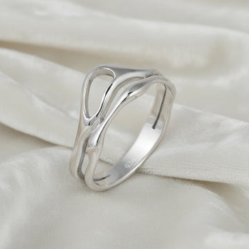 A side angle of a polished wave band ring on a white velvet background as a classic sterling silver rings for women's accessories