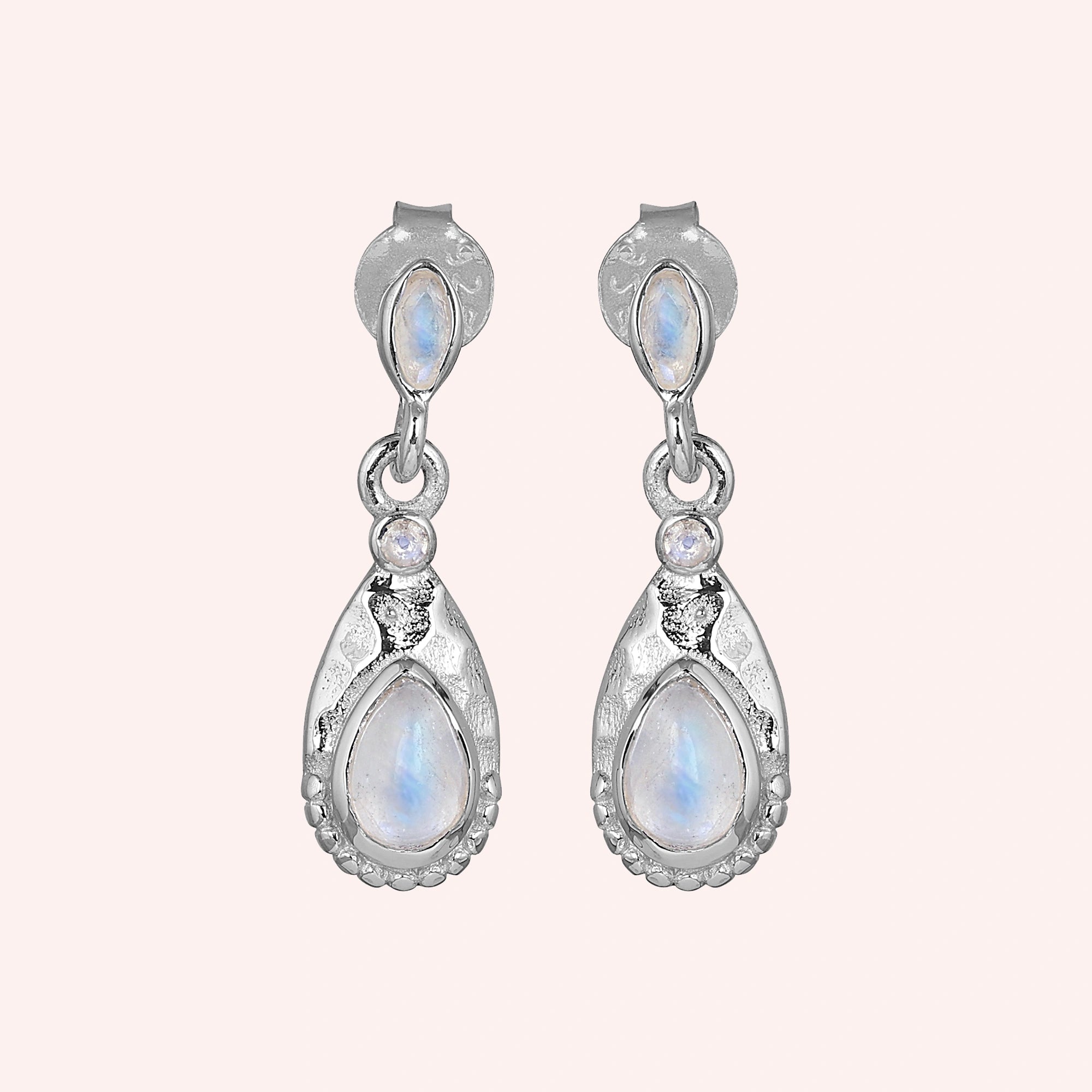 Teardrop_earrings_sterling_silver_with_moonstone_in_front_angled_view_on_solid_pink_background