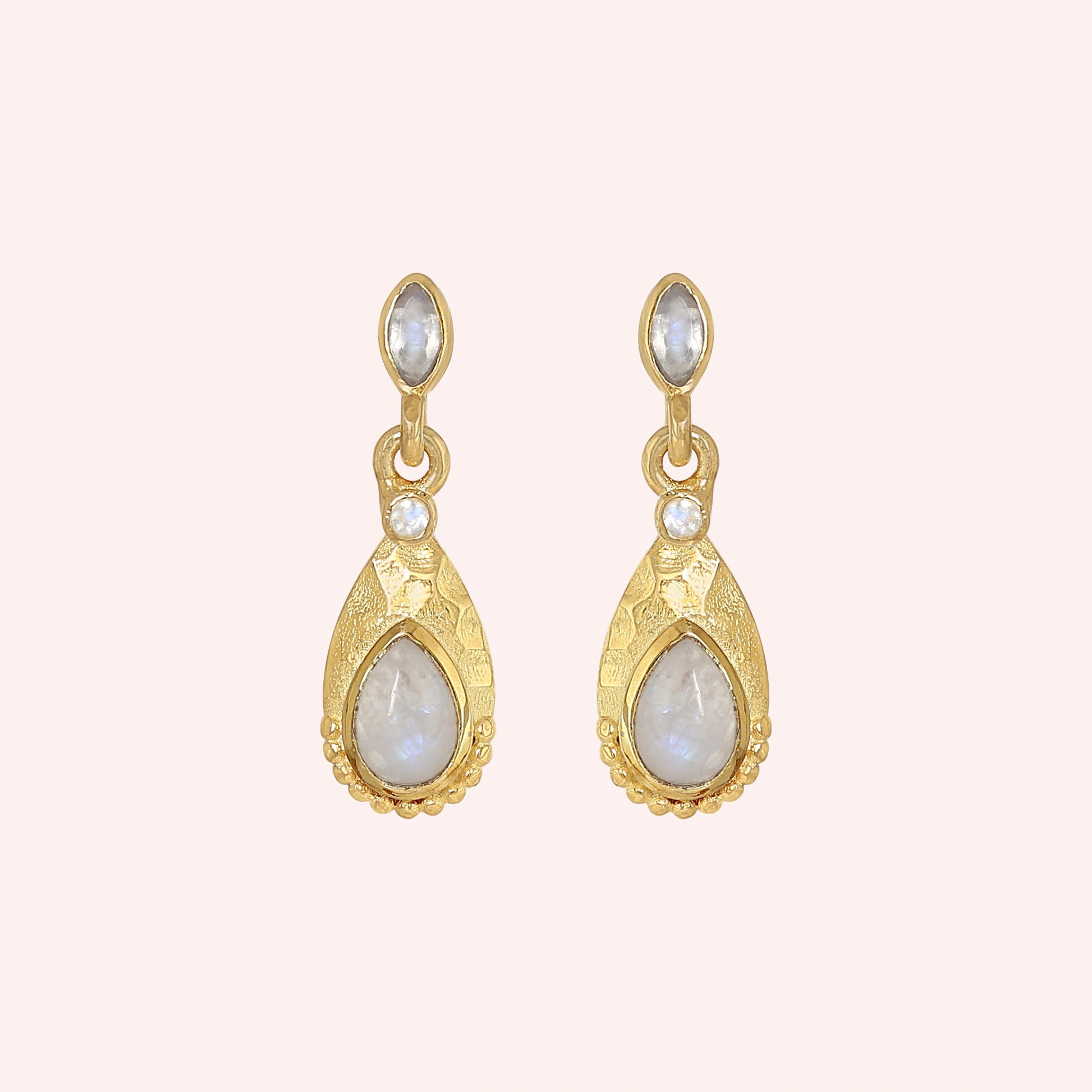 Teardrop_earrings_gold_plated_silver_with_moonstone_in_front_angled_view_on_solid_pink_background
