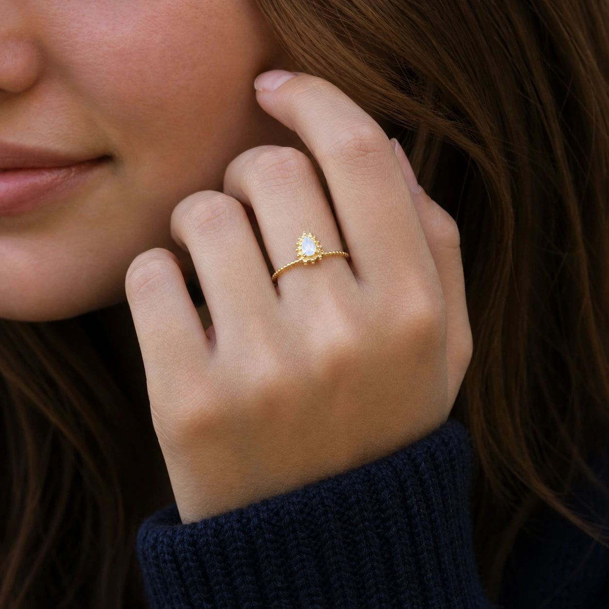 Teardrop_ring_gold_plated_silver_beaded_band_with_moonstone_worn_by_a_model