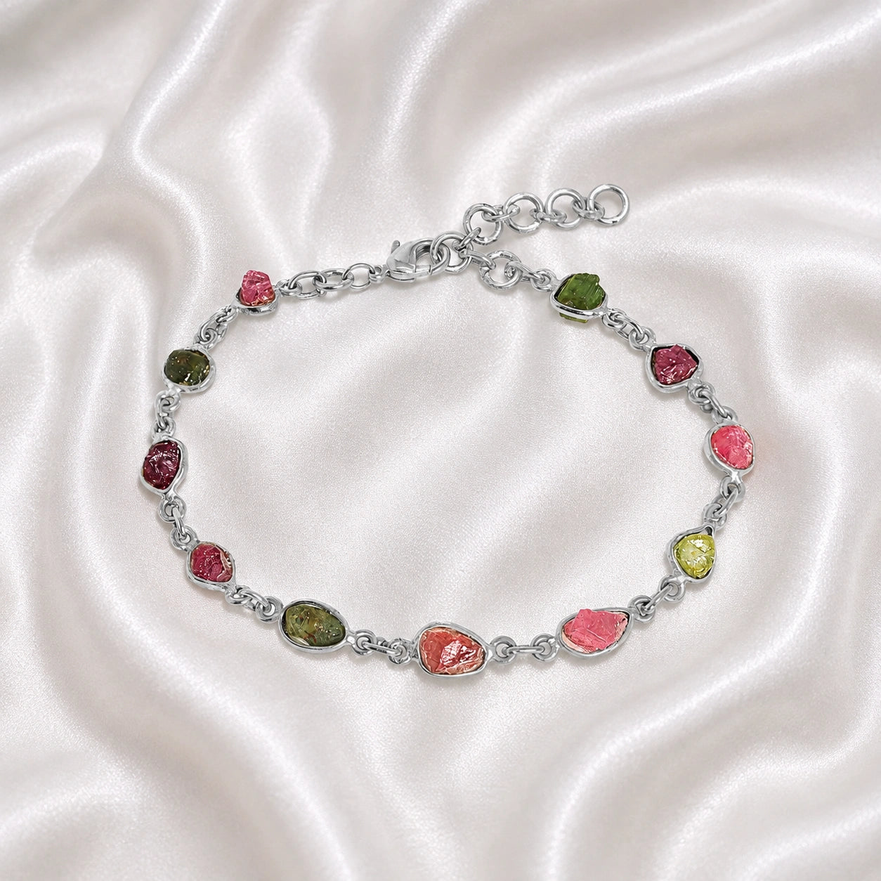 Tourmaline_bracelet_with_rough_tourmaline_stones_in_sterling_silver_at_front_angle_view_on_soft_fabric_background