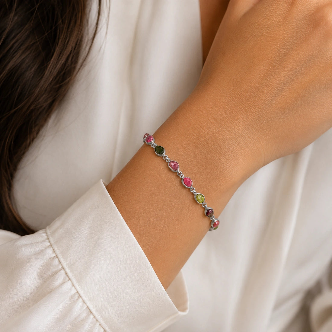 Tourmaline_bracelet_with_rough_tourmaline_stones_in_gold_plated_silver_at_front_angle_view_on_soft_fabric_background
